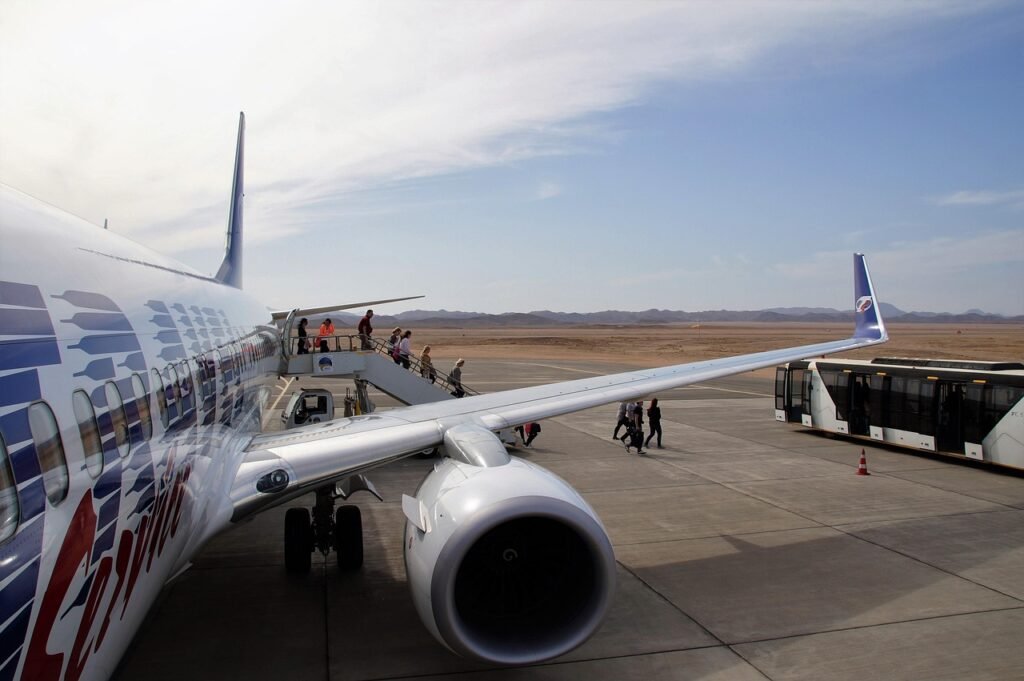 Passengers boarding a plane on the airport apron